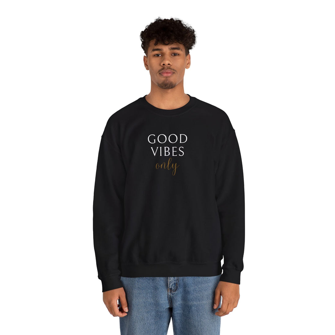 Man wearing black Good Vibes Sweatshirt with white and gold text