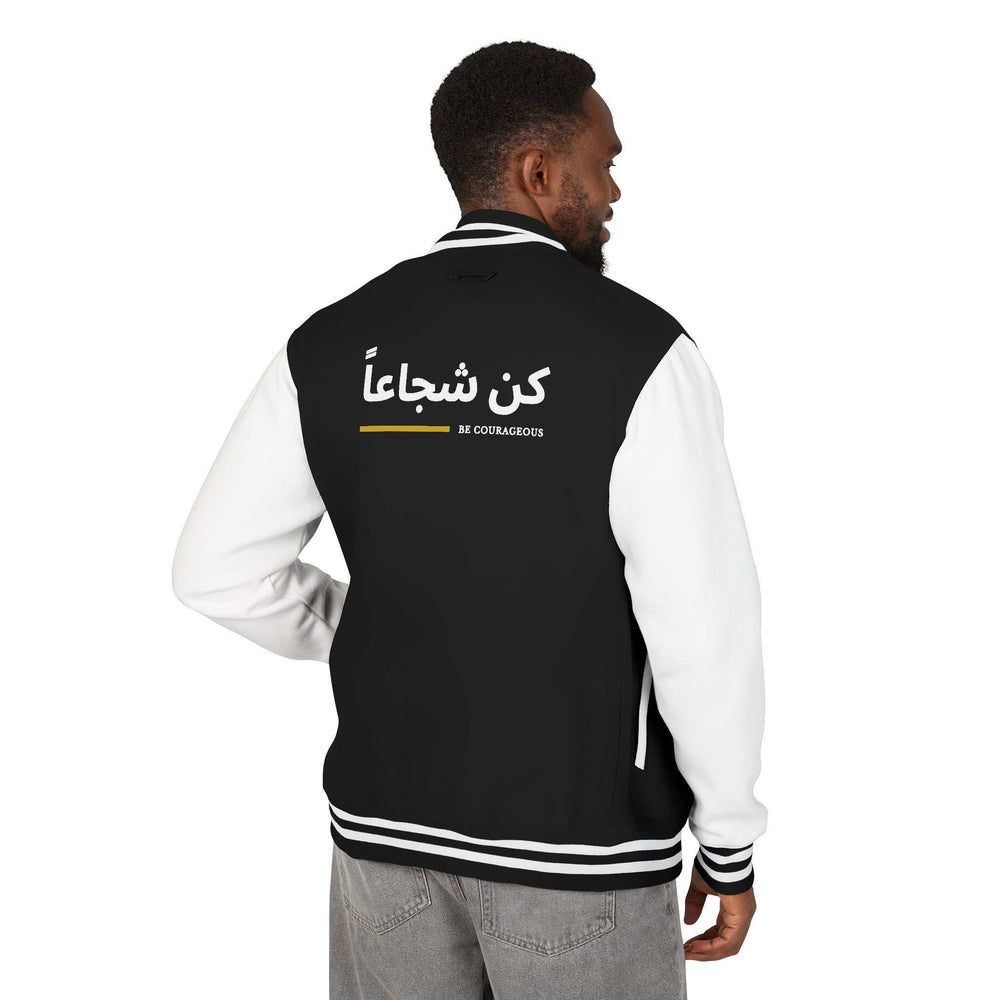 Black and white Be Courageous jacket with Arabic calligraphy on the back, made of cotton and polyester blend for comfort and style.
