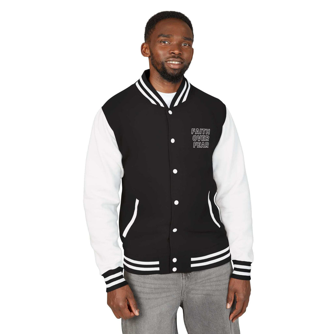 Black and white varsity jacket with "Faith Over Fear" text, made of cotton and polyester blend, medium-heavy fabric for warmth and style