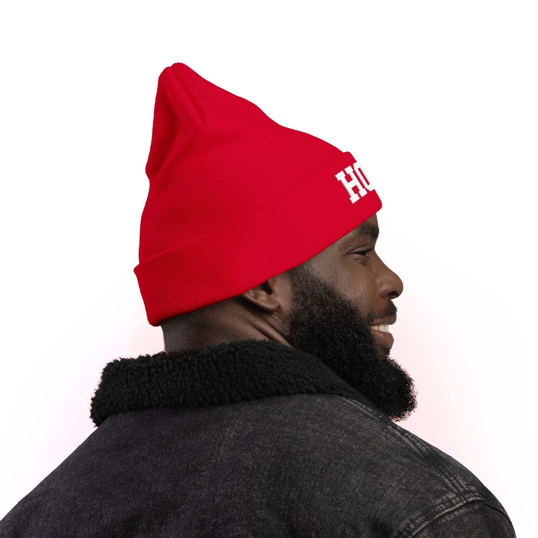 Side view of a man wearing a red Hope Knit Beanie with a black jacket