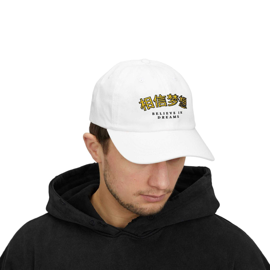 Man wearing white Believe In Dreams Cap with black hoodie