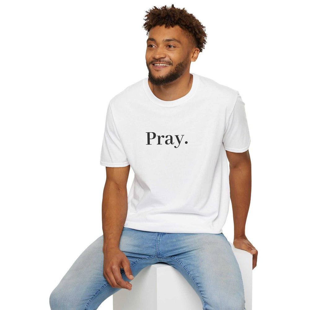 Man wearing white Pray T-shirt made of 100% cotton with classic fit and tear-away label sitting on white block
