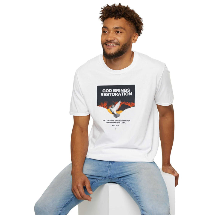 Man wearing white Restored by Grace T-Shirt with "God Brings Restoration" text and dove graphic, paired with light blue jeans