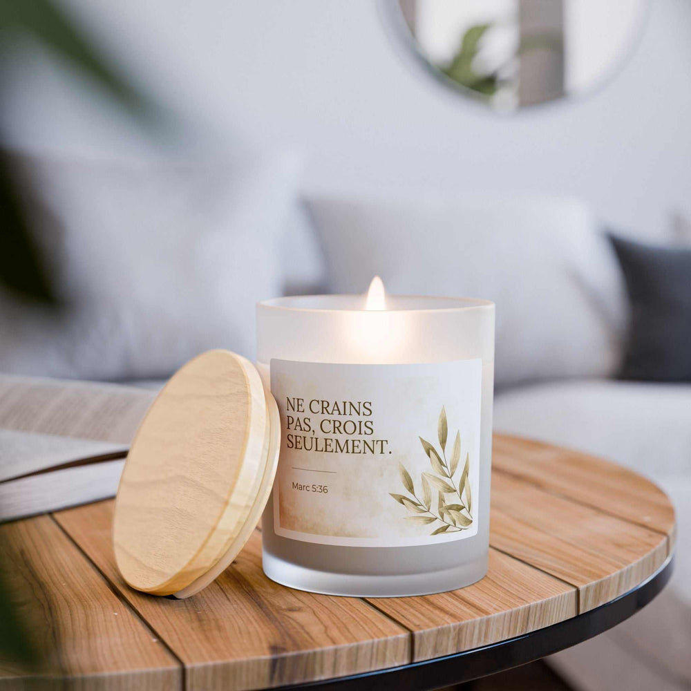 Mark 5:36 French verse candle in frosted glass with wooden lid and natural coconut soy wax burning on wooden table