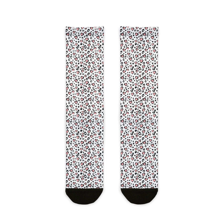 Pair of white crew socks with leopard print hearts pattern