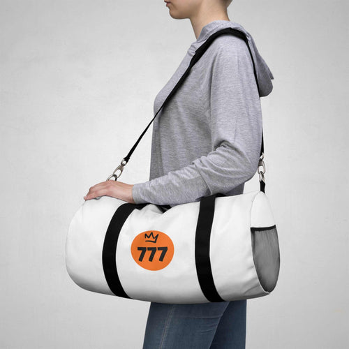 Person carrying white 777 Duffel Bag with black straps over shoulder