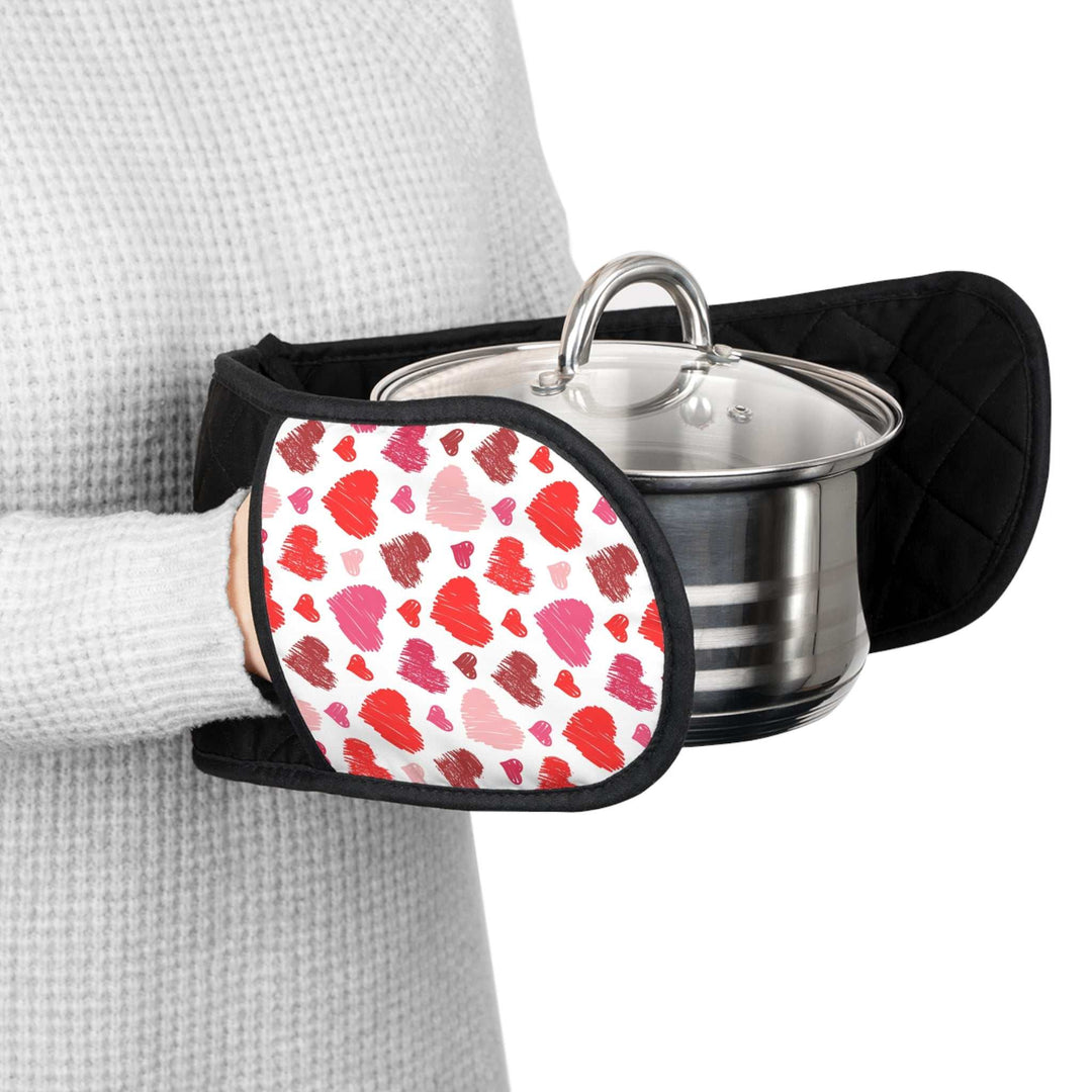 Person holding pot with Love Design Oven Mitts