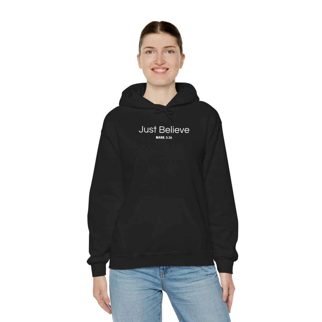 Person wearing black Just Believe Hoodie with kangaroo pocket