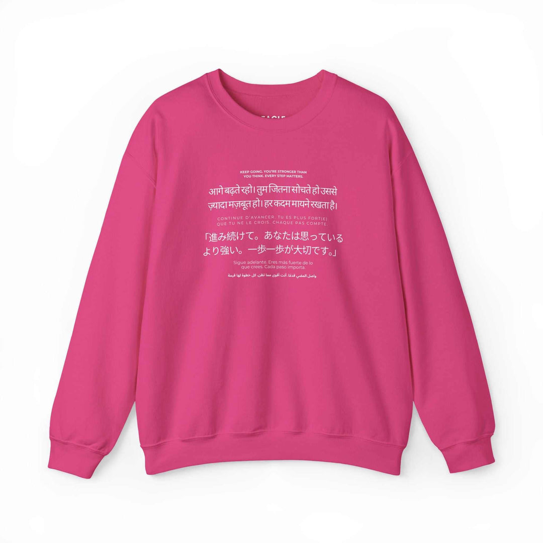 Pink Keep Going sweatshirt with motivational text in multiple languages, classic fit and soft fabric blend