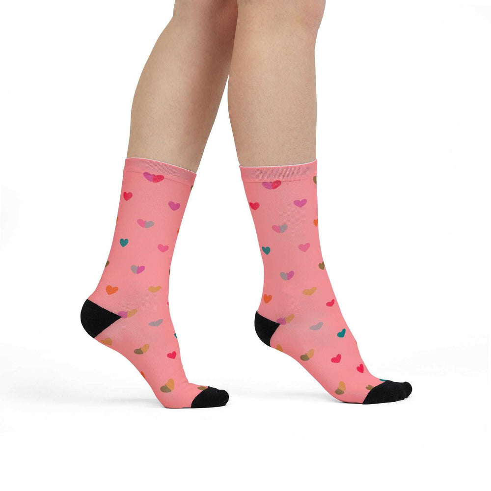 Pink crew socks with multicolored hearts pattern