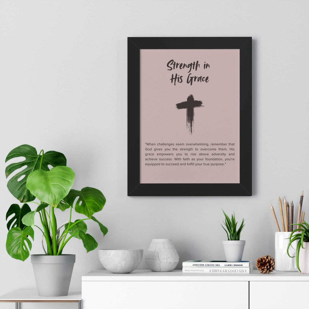 Framed "Strength in His Grace" inspirational poster with a cross design, displayed above a white shelf with plants and decorative items.