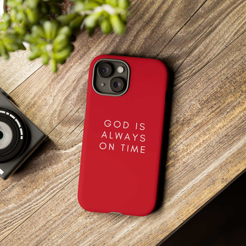Red phone case with "God is always on time" text, durable dual-layer protection and matte finish.