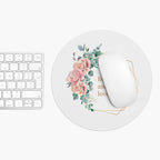 Round floral Be Kind mouse pad with inspirational message and white wireless mouse on desk next to keyboard