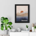 Succeed framed poster with motivational text and abstract landscape in black wood frame on wall above white cabinet with plants and decor