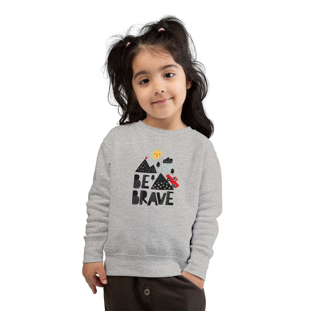 Toddler wearing gray Be Brave sweatshirt with mountain and car graphic