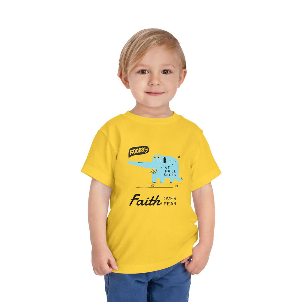 Toddler wearing yellow Faith Over Fear tee with blue graphic