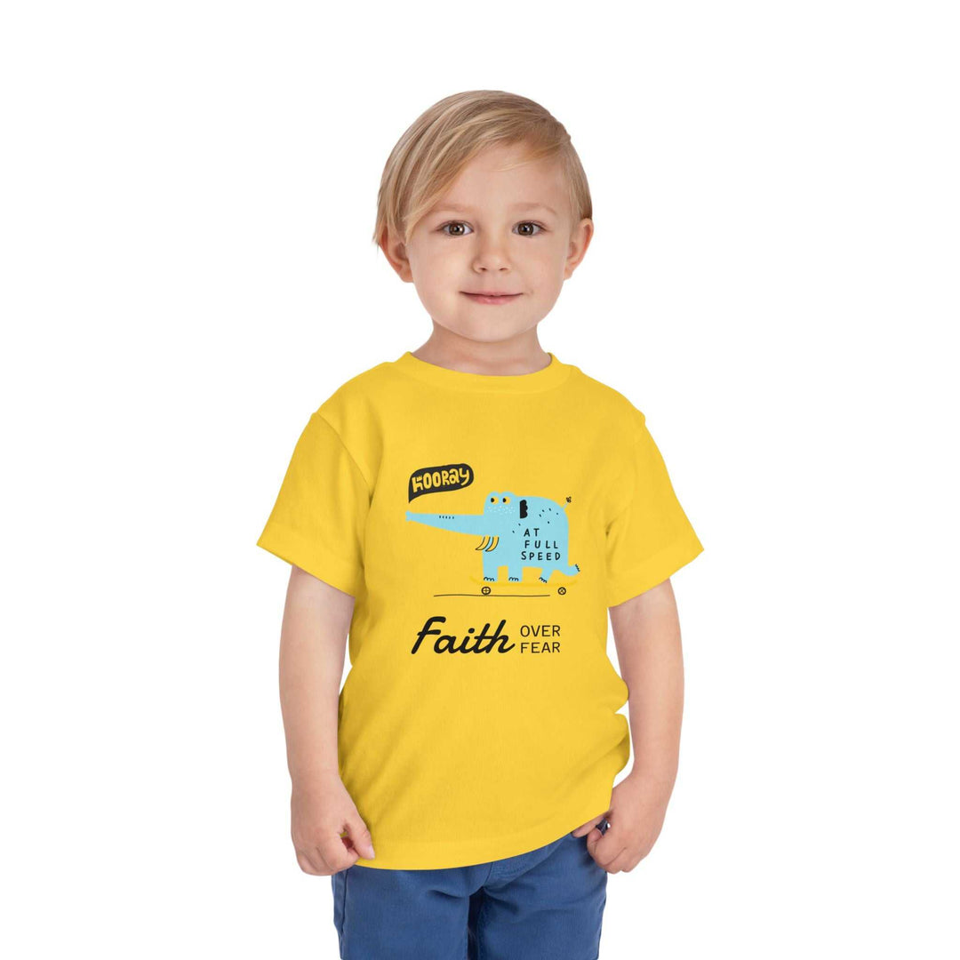 Toddler wearing yellow Faith Over Fear tee with blue graphic