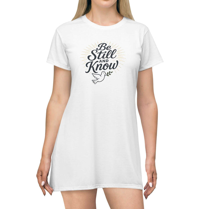 White Be Still T-Shirt Dress with printed text and dove graphic