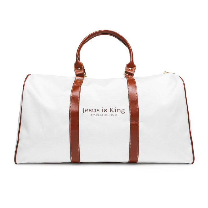 White and brown Jesus is King travel bag with gold zipper and leather handles