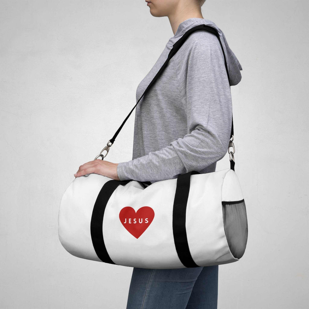 White Jesus duffel bag with black straps and red heart logo