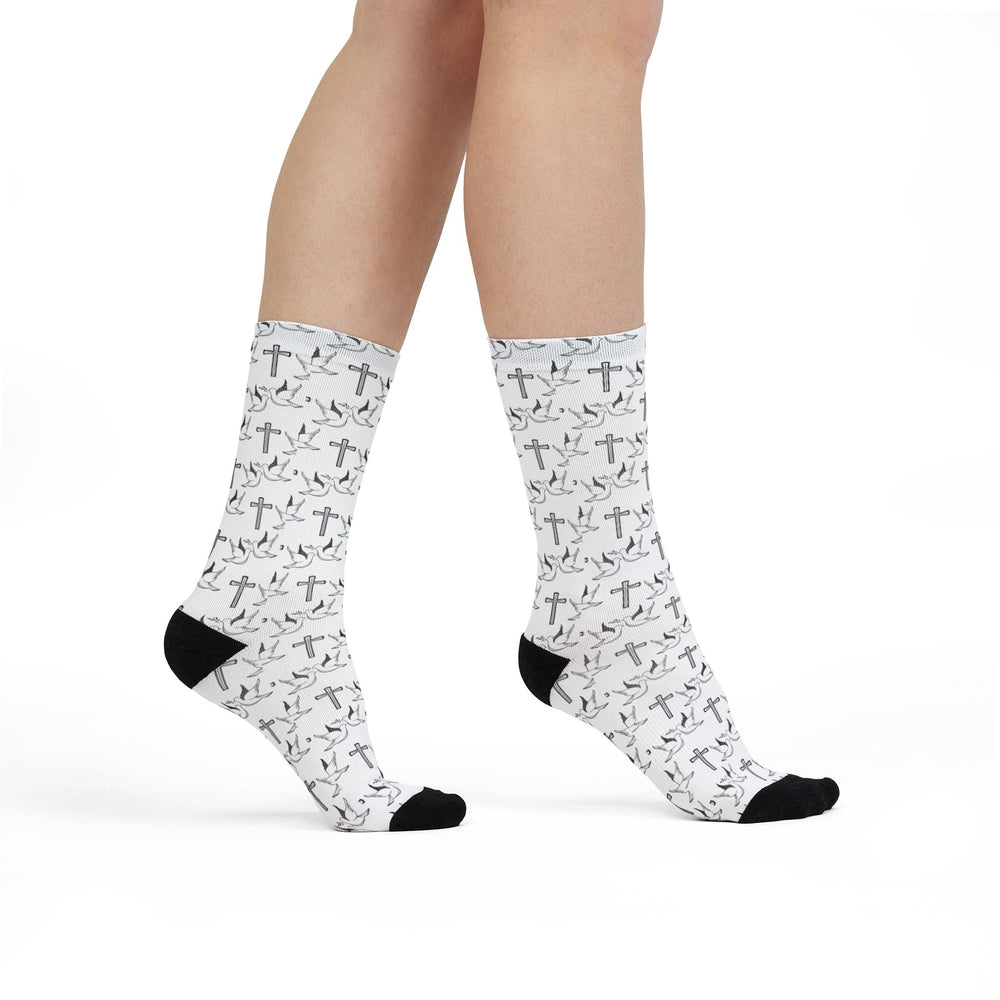 White crew socks with black heels and toes featuring biblical symbols