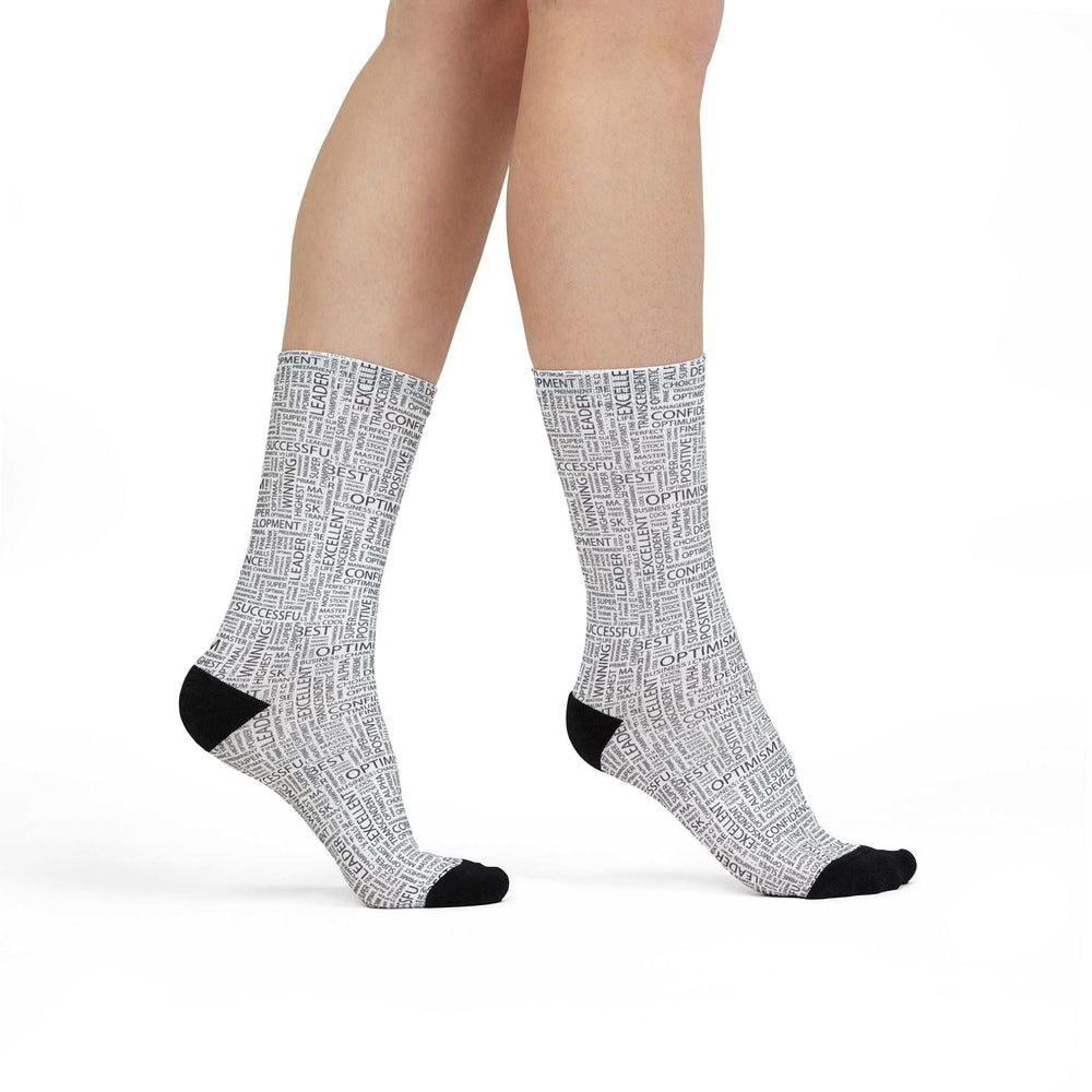 White crew socks with positive words all over and black heel