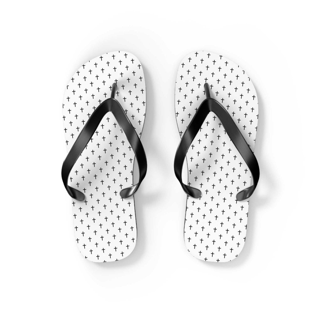 White flip flops with black cross patterns and black straps