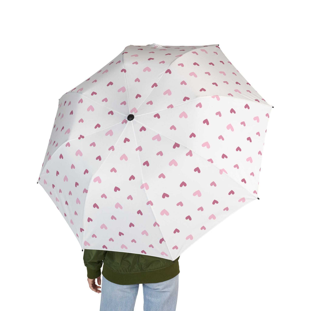 White umbrella with pink hearts pattern