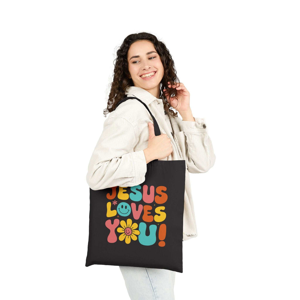 Woman carrying God’s Love Tote Bag with "Jesus Loves You" design
