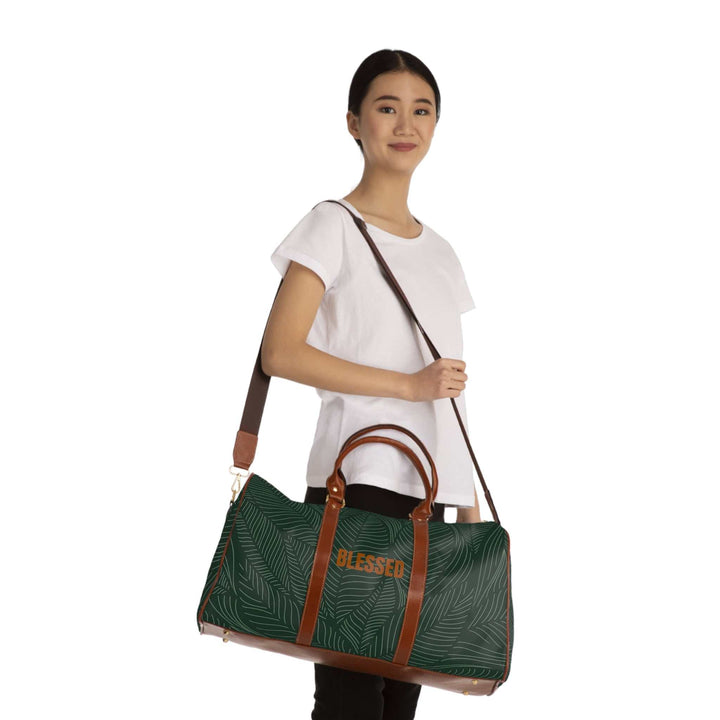 Woman carrying green tropical travel bag with brown PU leather handles