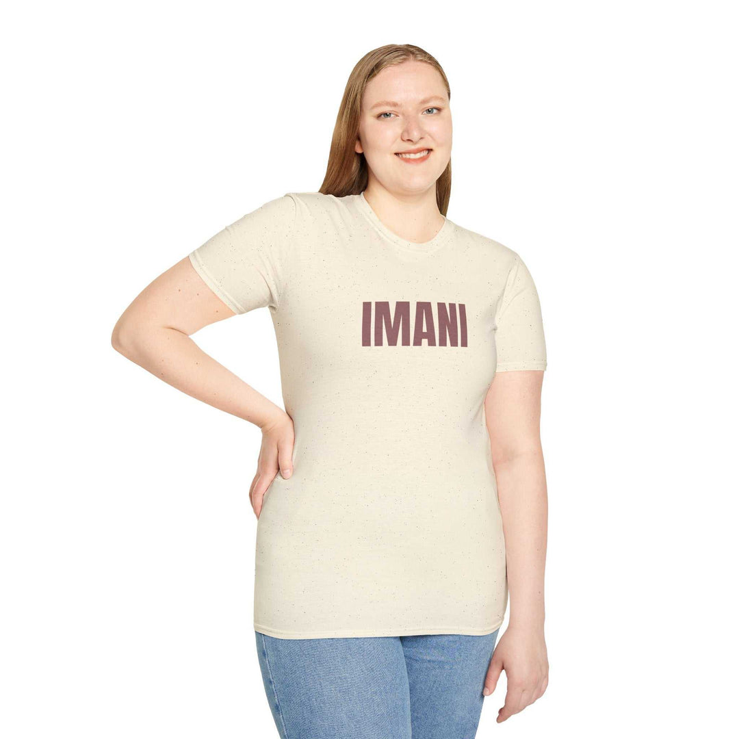 Woman wearing beige Imani T-shirt with bold text, paired with blue jeans, classic fit made of 100% ring-spun cotton