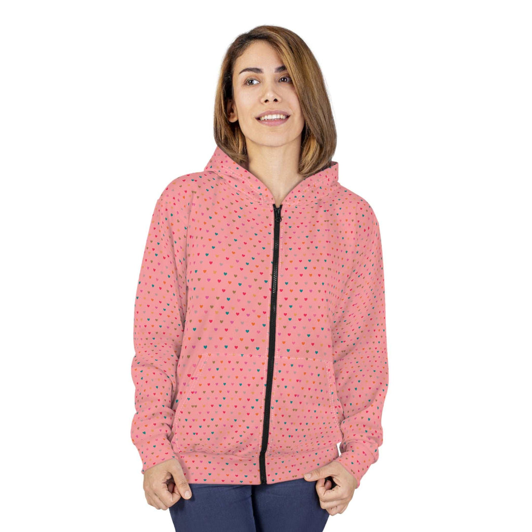 Woman wearing a pink Hearts Pattern Zip Hoodie with black zipper