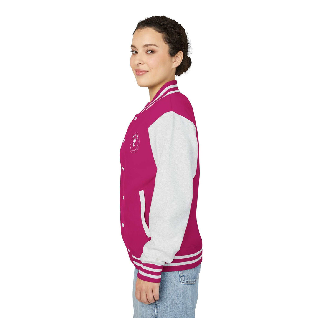 Woman wearing a Dios Es Amor jacket in magenta with grey sleeves and striped cuffs, showcasing a faith-inspired design.