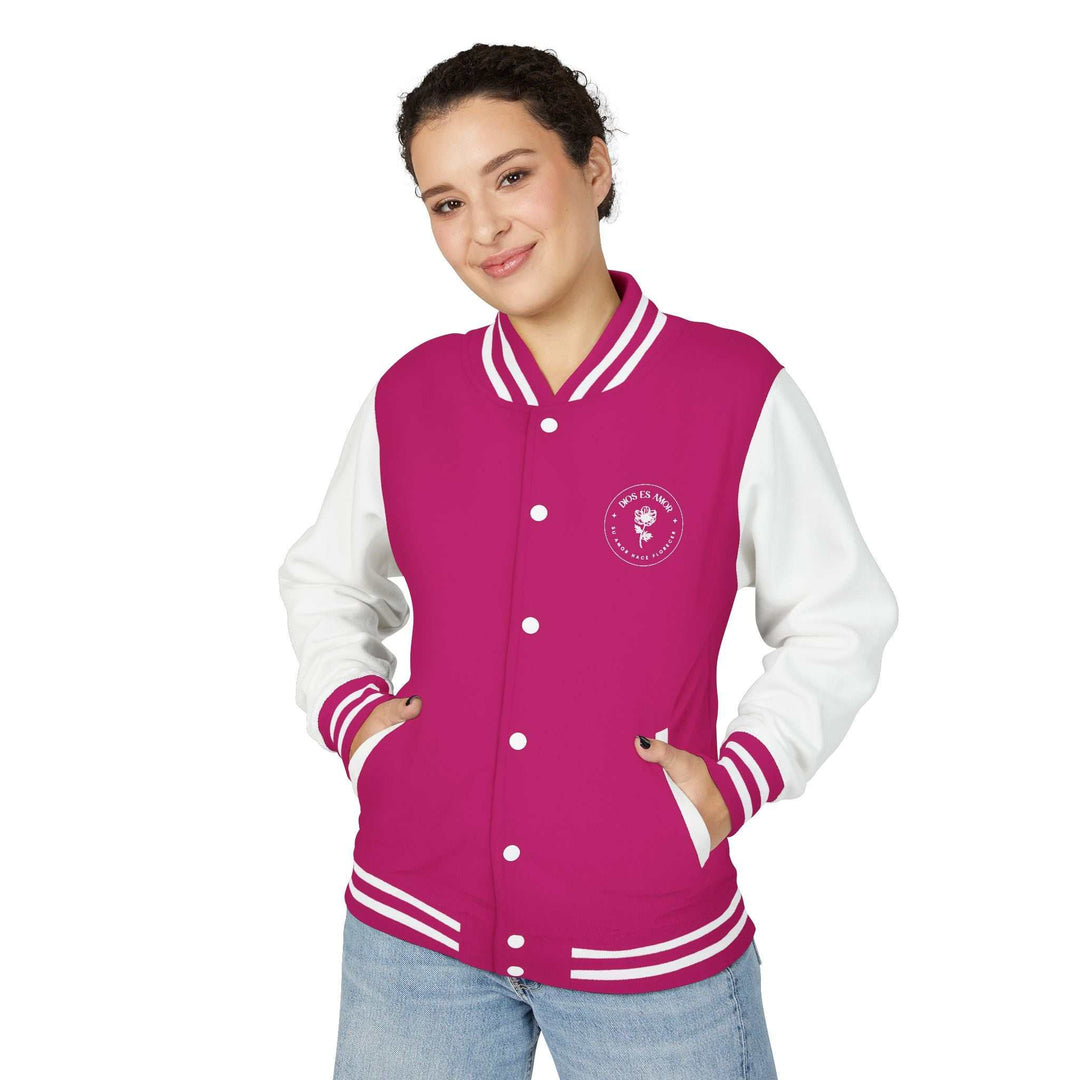 Woman wearing a pink and white Dios Es Amor jacket with front buttons and striped cuffs, expressing faith and comfort