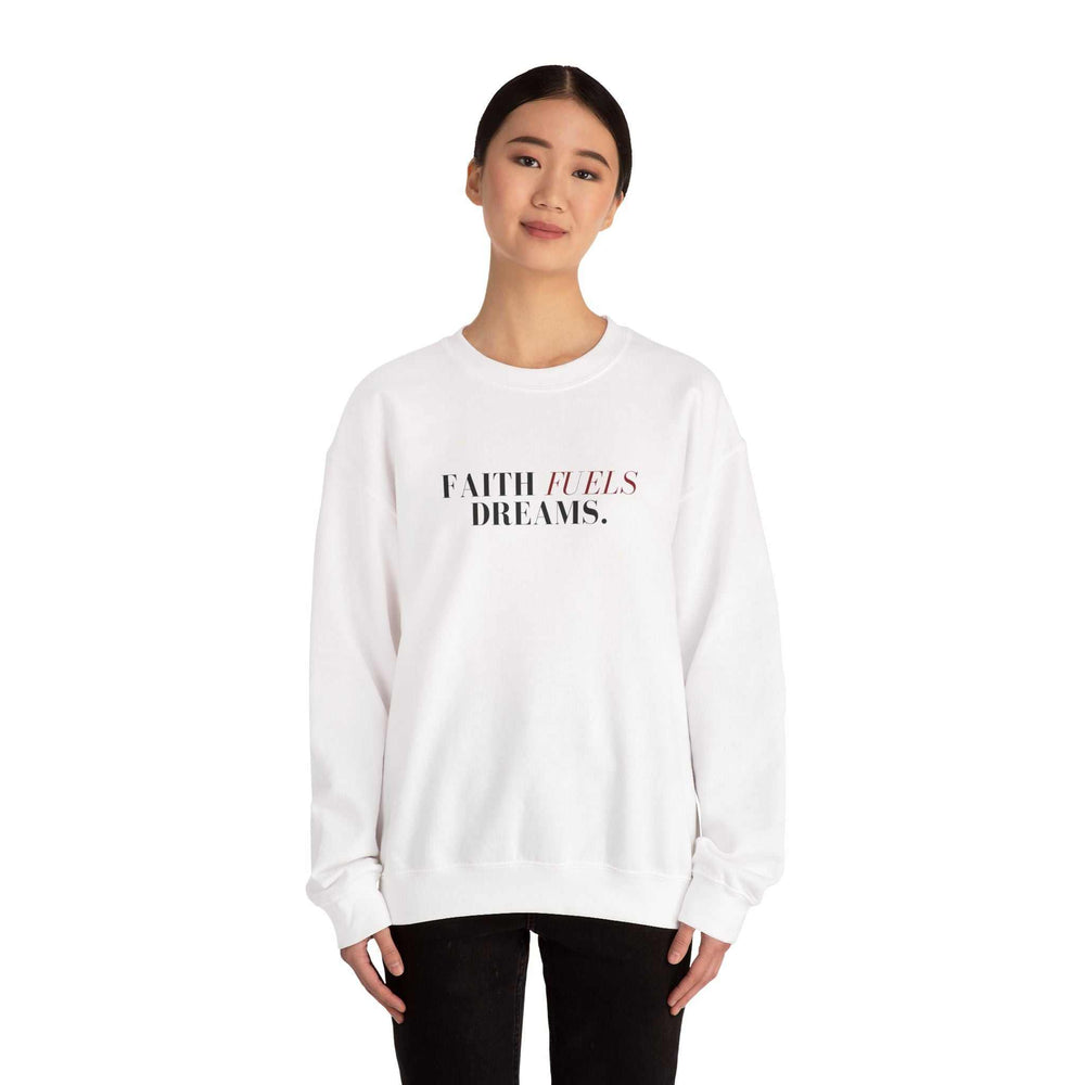 Woman wearing a white Faith Fuels Dreams sweatshirt with classic fit and motivational text design