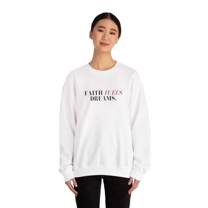 Woman wearing a white Faith Fuels Dreams sweatshirt with classic fit and motivational text design