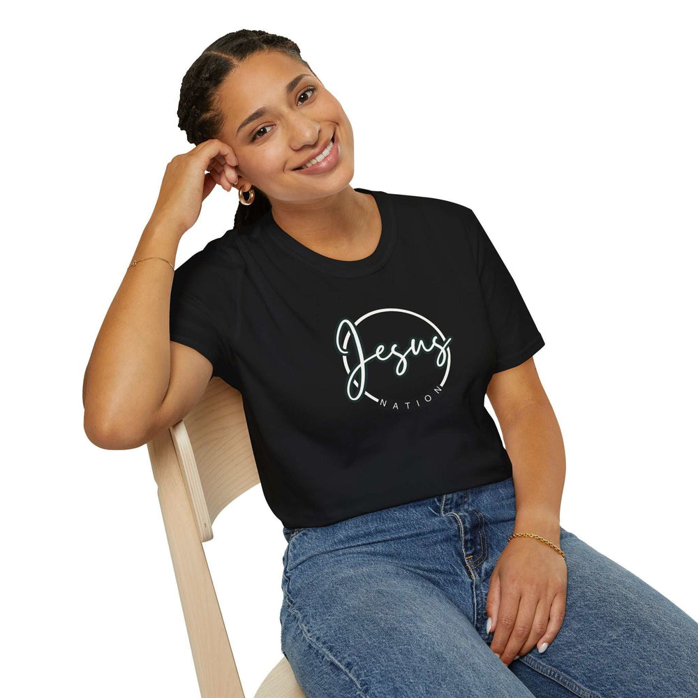 Woman wearing black Jesus Nation t-shirt made of 100% cotton with classic fit sitting on wooden chair