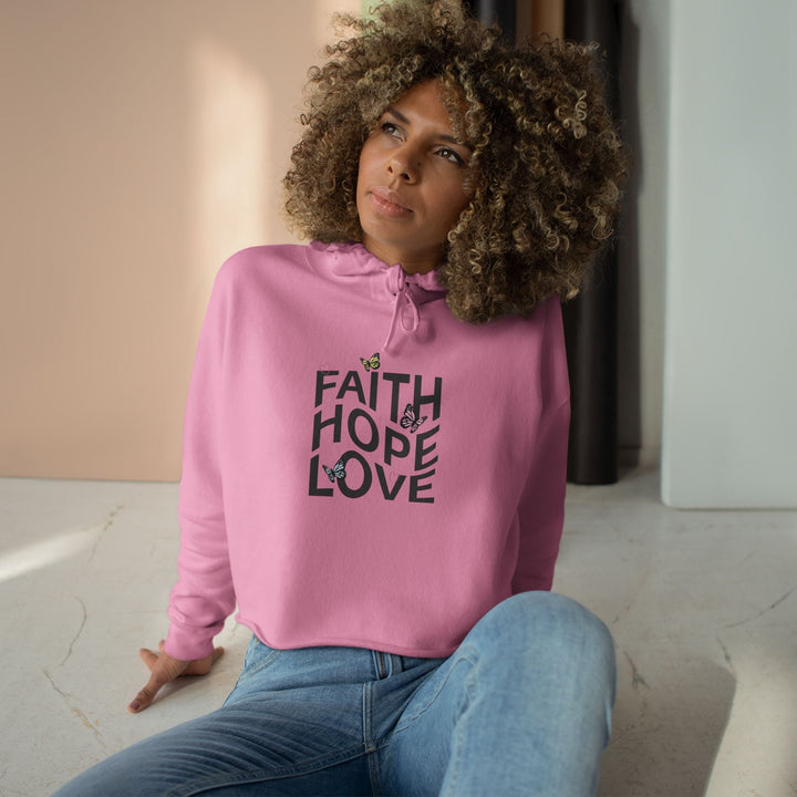 Woman wearing pink Faith Hope Crop Hoodie with butterfly design