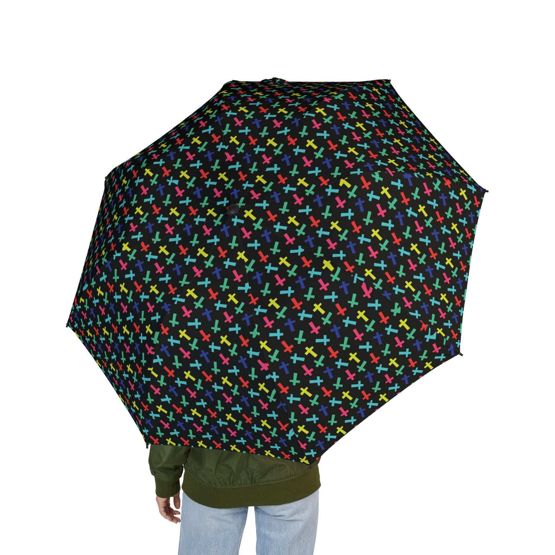 black umbrella with colorful crosses pattern held by person