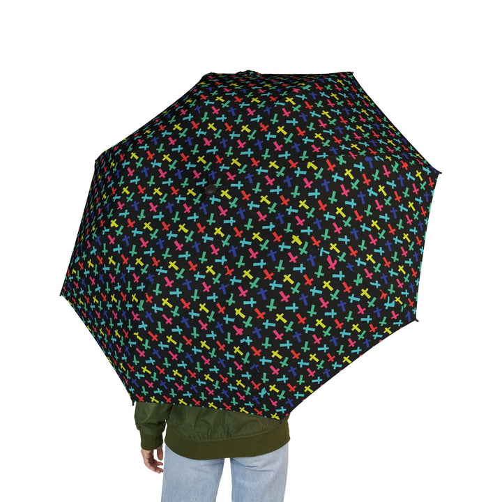black umbrella with colorful crosses pattern held by person