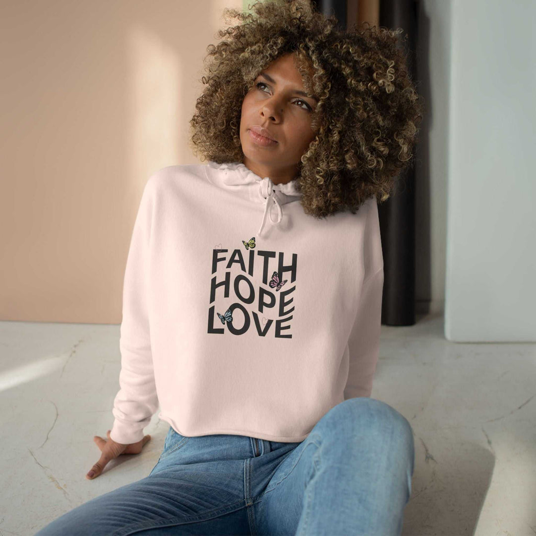 woman wearing stylish soft pink crop hoodie with Faith Hope Love text